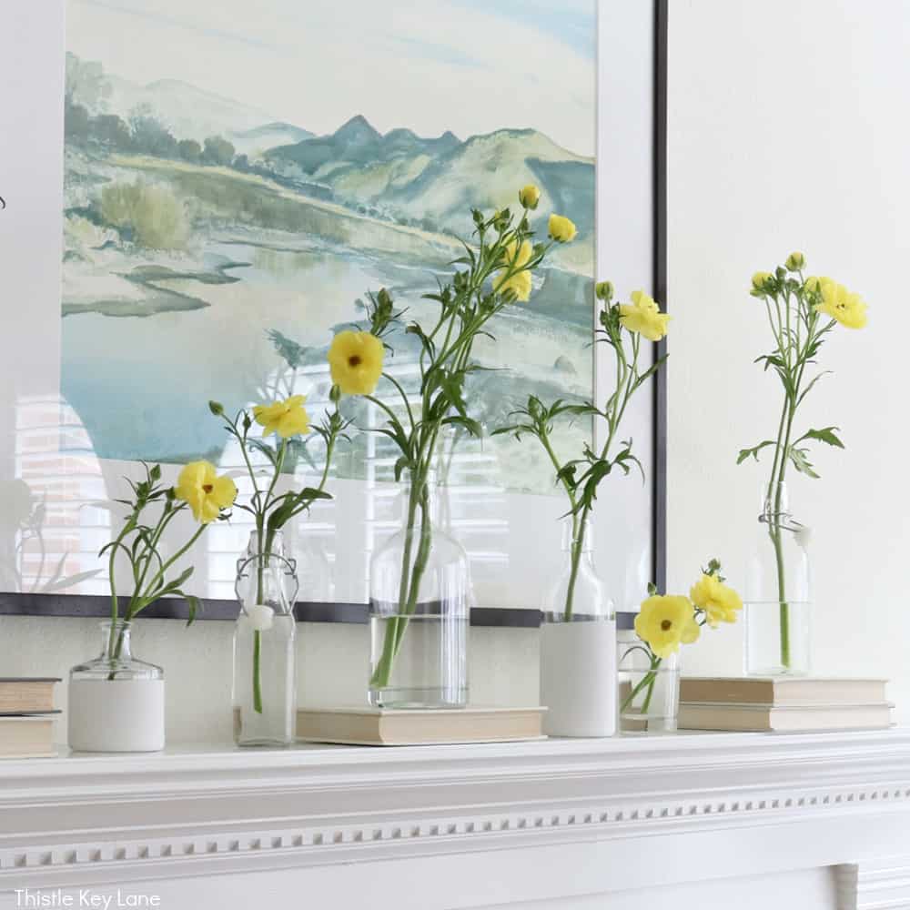 Spring Mantel With Flowers And Bottle Vases