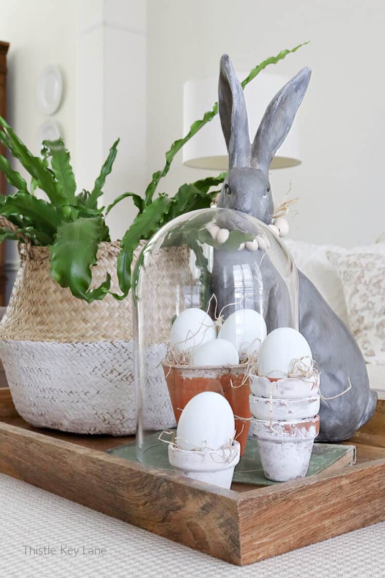 Wooden eggs in terra cotta pots. Three Spring Ottoman Or Coffee Table Vignettes.