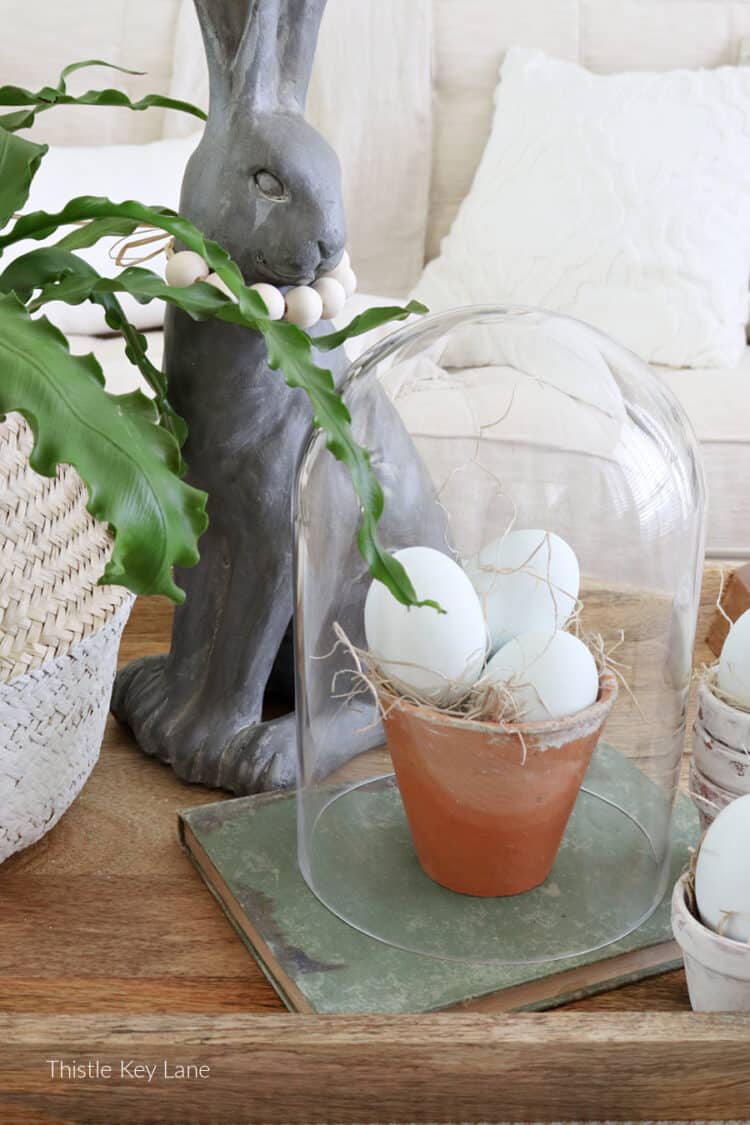 Rabbit, cloche with eggs and fern. Three Spring Ottoman Or Coffee Table Vignettes.