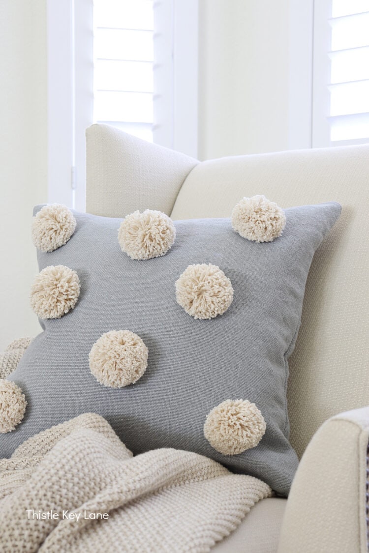 Grey pom pom pillow best sale