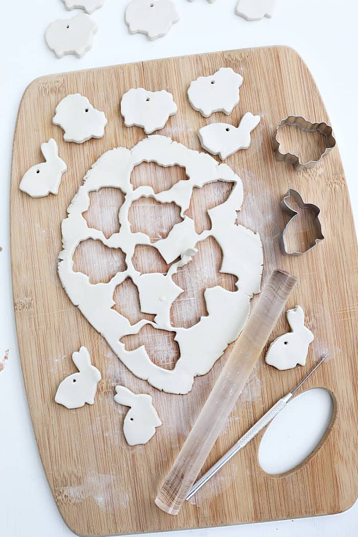 Rolling out clay and using cookie cutters for figures. 
