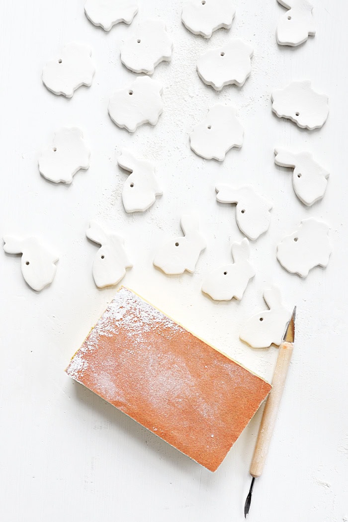 Smoothing out clay with sanding sponge.