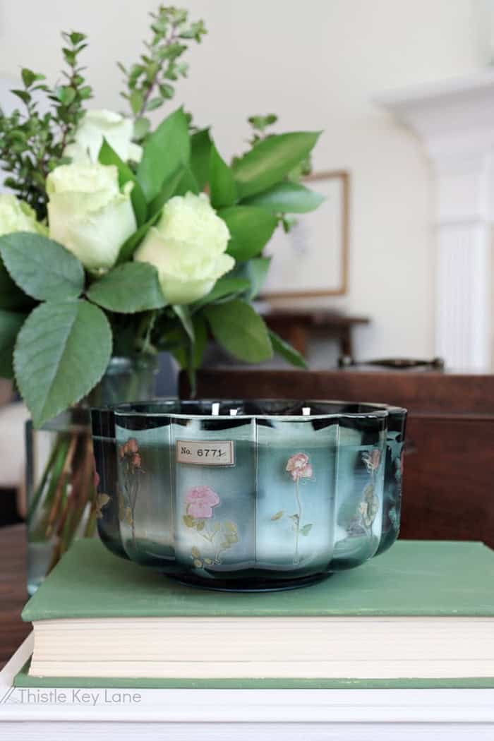 Rose arrangement, large glass candle and books. Anthropologie Inspired Candles DIY.