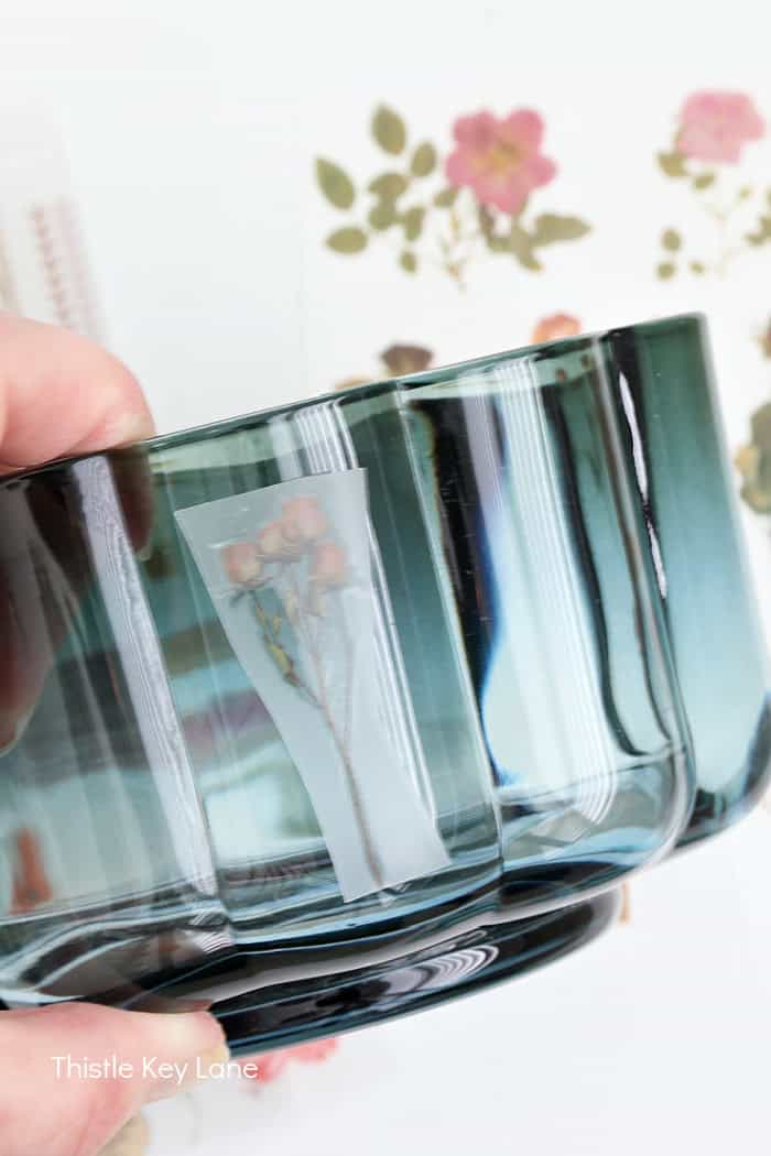 Rose transfer being applied to glass. Anthropologie Inspired Candles DIY.