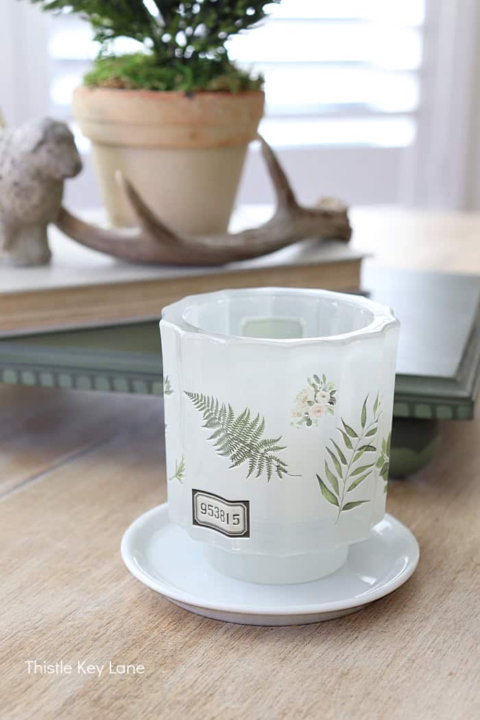Green and white candle holder on a table. Anthropologie Inspired Candles DIY.