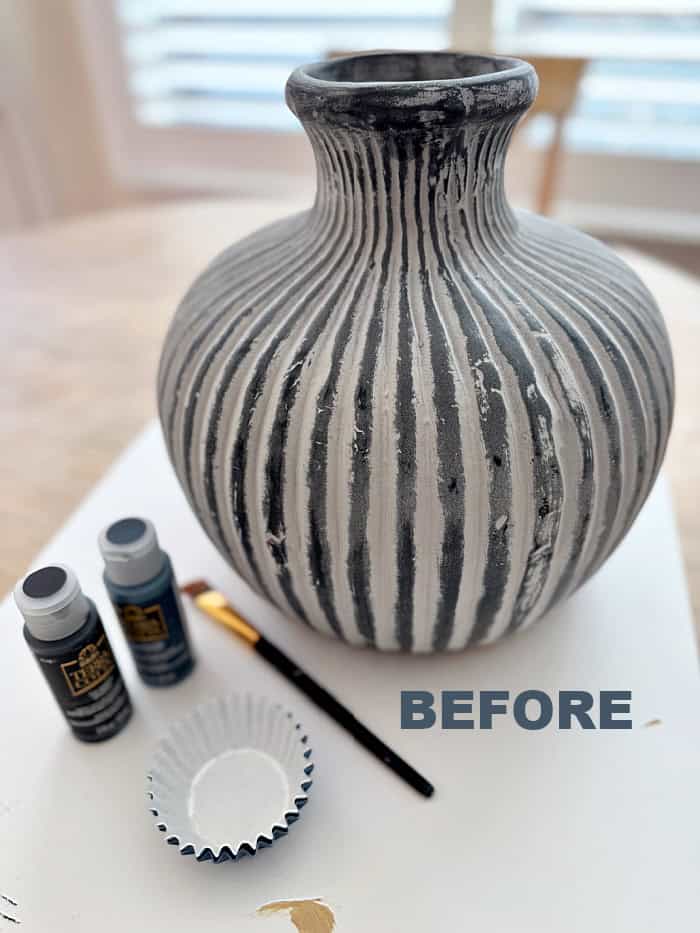 Before photo of black and white vase.