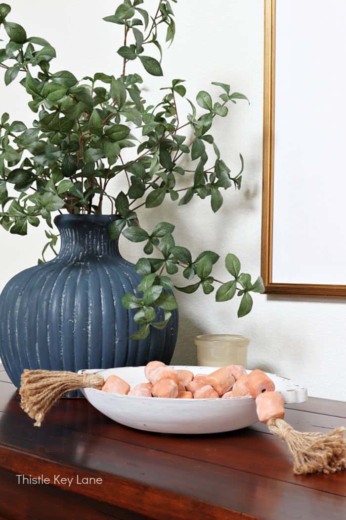 White bowl and blue vase with greenery. Entry Table Update With A Vase Makeover.