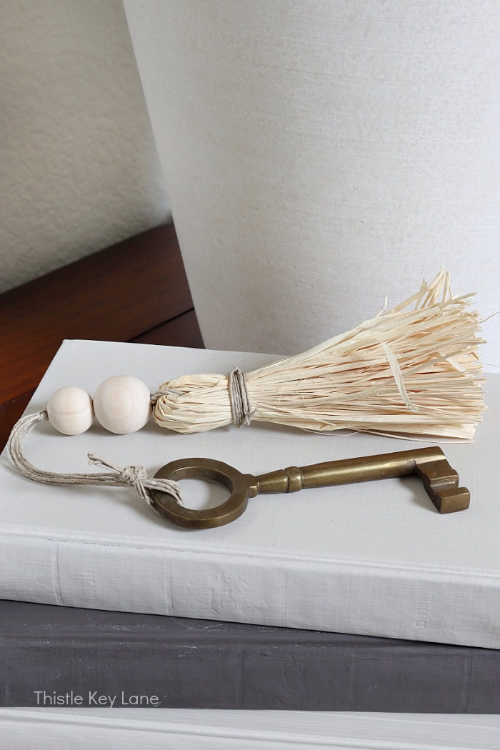 Raffia tassel attached to a brass key. Entry Table Update With A Vase Makeover.