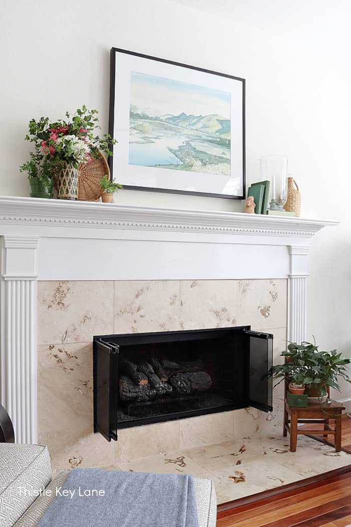 Side view of the mantel and hearth. Vintage Spring Mantel Decor Styling.