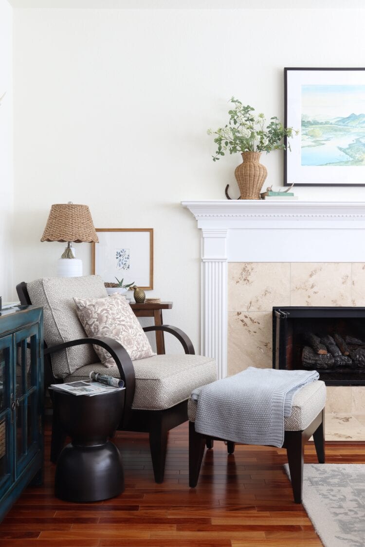 Arm chair with ottoman lamp and table.