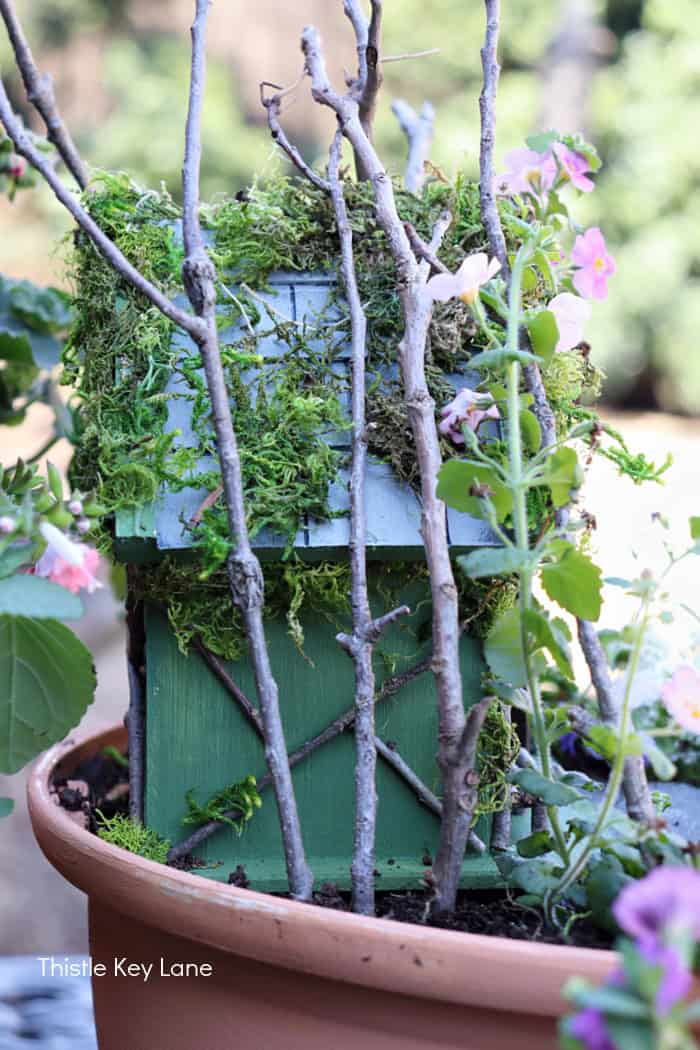 Add larger sticks to secure the house in the flower pot. How To Make A Flower Pot Fairy Garden.