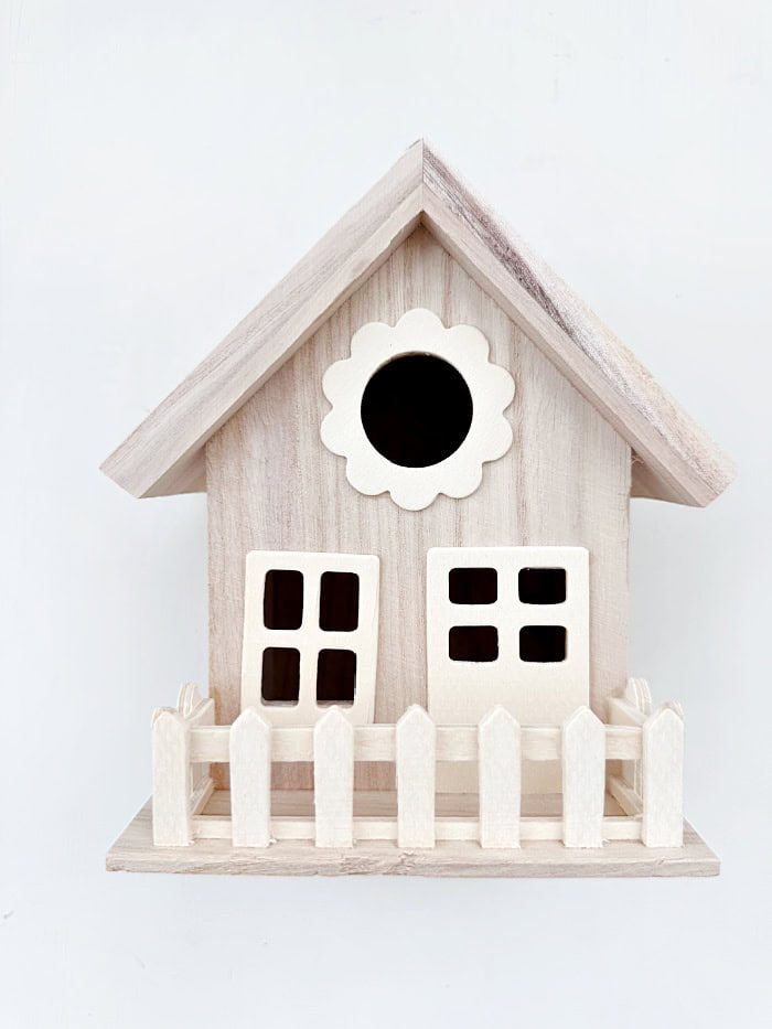 Small bird house with fence.