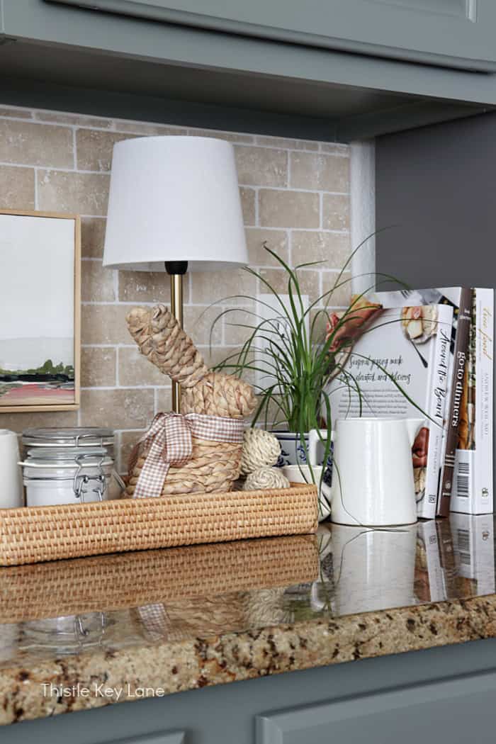 Tray, lamp, pitcher and cookbooks on counter. Soft Neutrals Spring Home Tour.