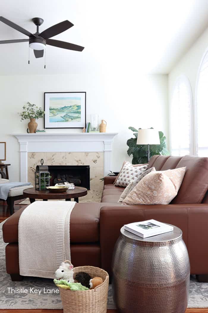 L shaped sofa with blanket and pillows. Soft Neutrals Spring Home Tour.