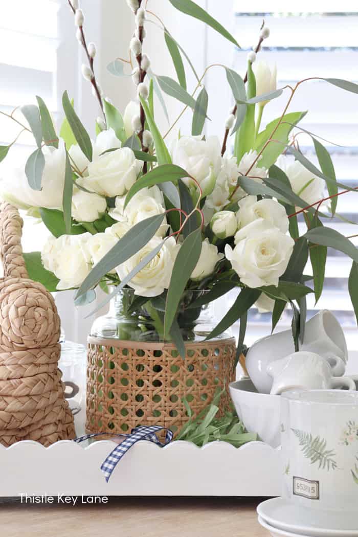White scallop tray with vignette. Woven bunny with clay carrots. Spring Tray Flower Centerpiece.