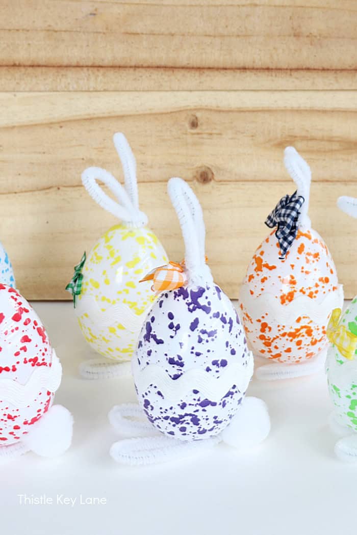 Side view of bunny eggs with pop-pom tails. DIY Easter Bunny Eggs. 