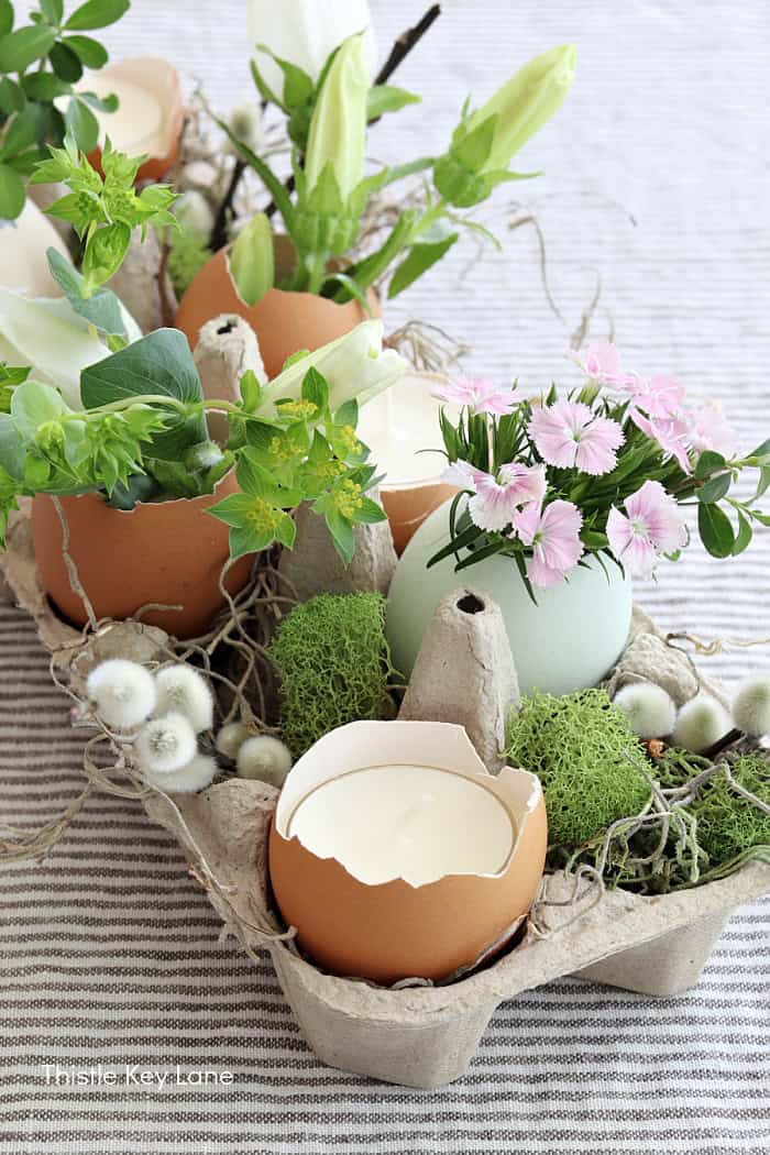 Pink and white flowers in egg vases. 