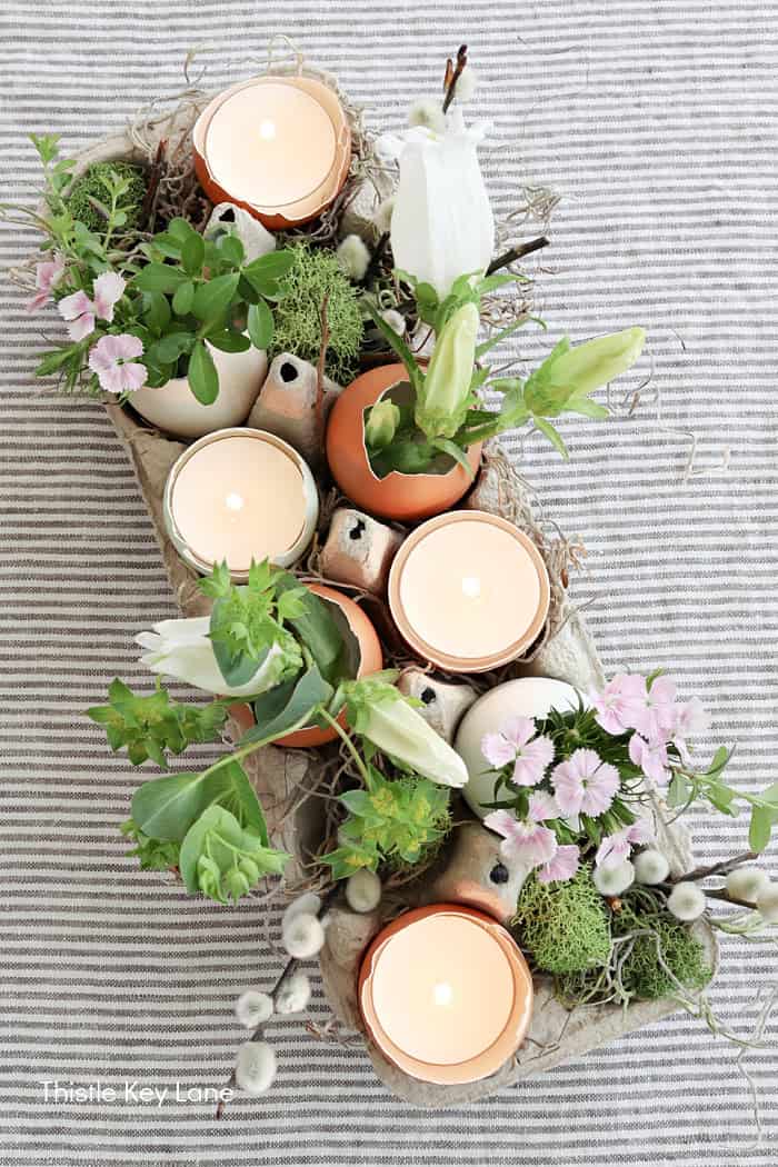 Fresh flowers, egg shells and candles. Rustic Easter Candle Arrangement.