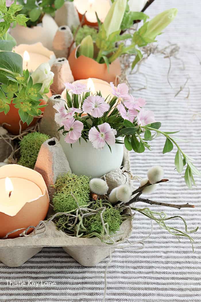 Puss willow and twigs mixed with flowers and candles. Rustic Easter Candle Arrangement.