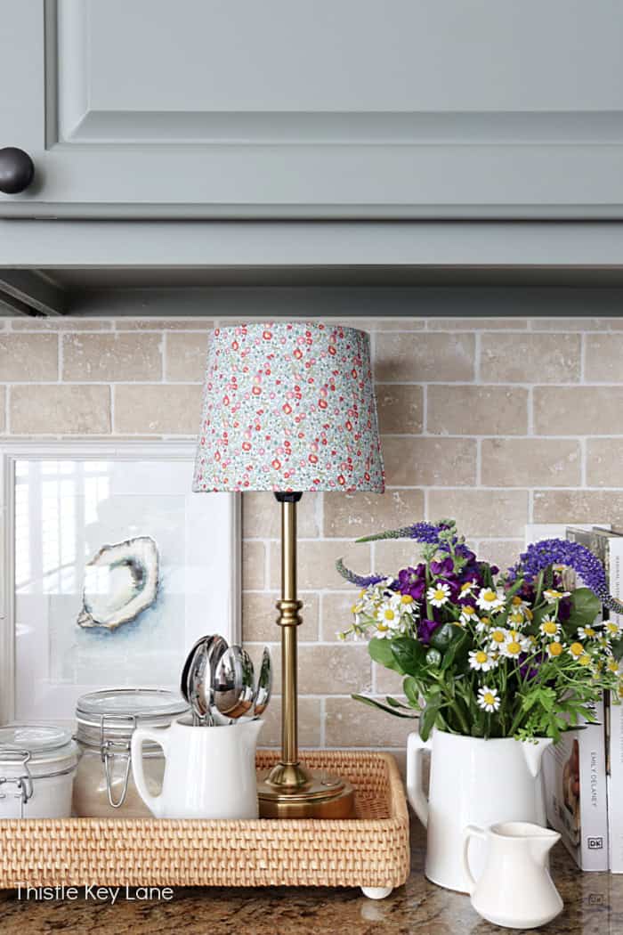Small cordless lamp on a tray in the kitchen. Lampshade Update With Fabric.