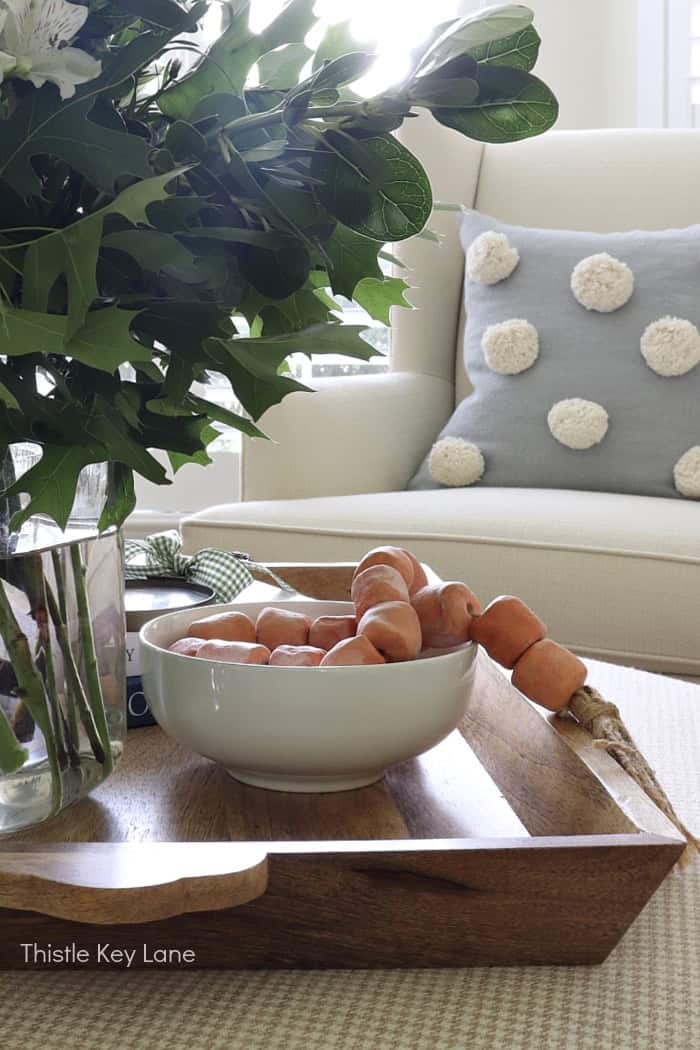 White bowl holding a clay bead garland.