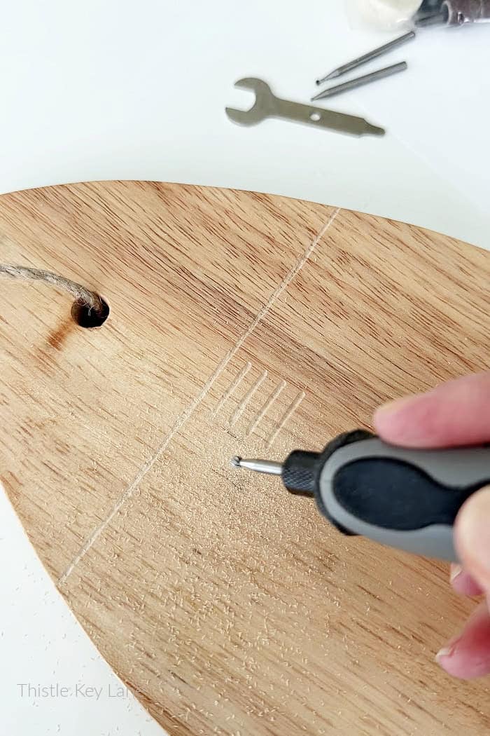 Using wood engraver to carve. 
