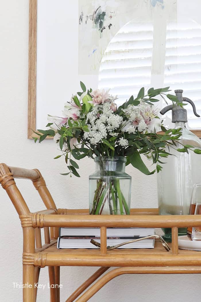Fresh flowers and seltzer bottles on the bar cart.
