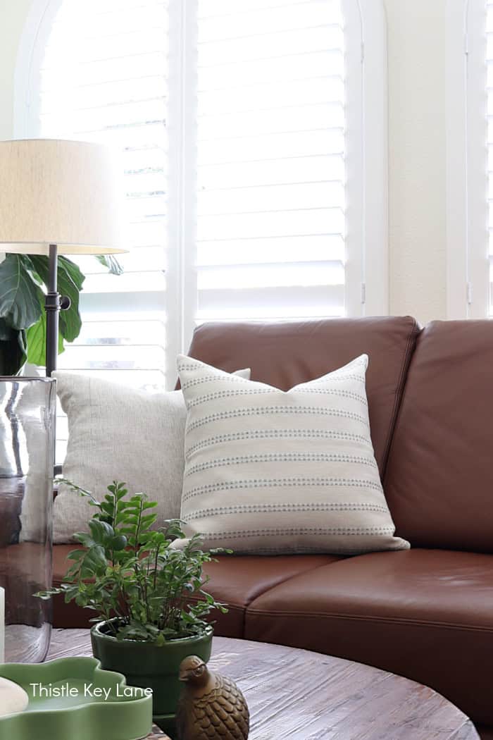 Summer pillows on leather sofa.