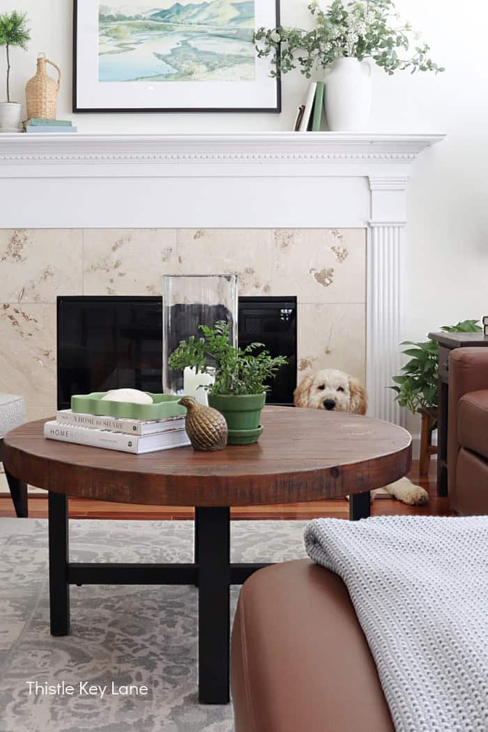 Coffee table gray rug fireplace. 