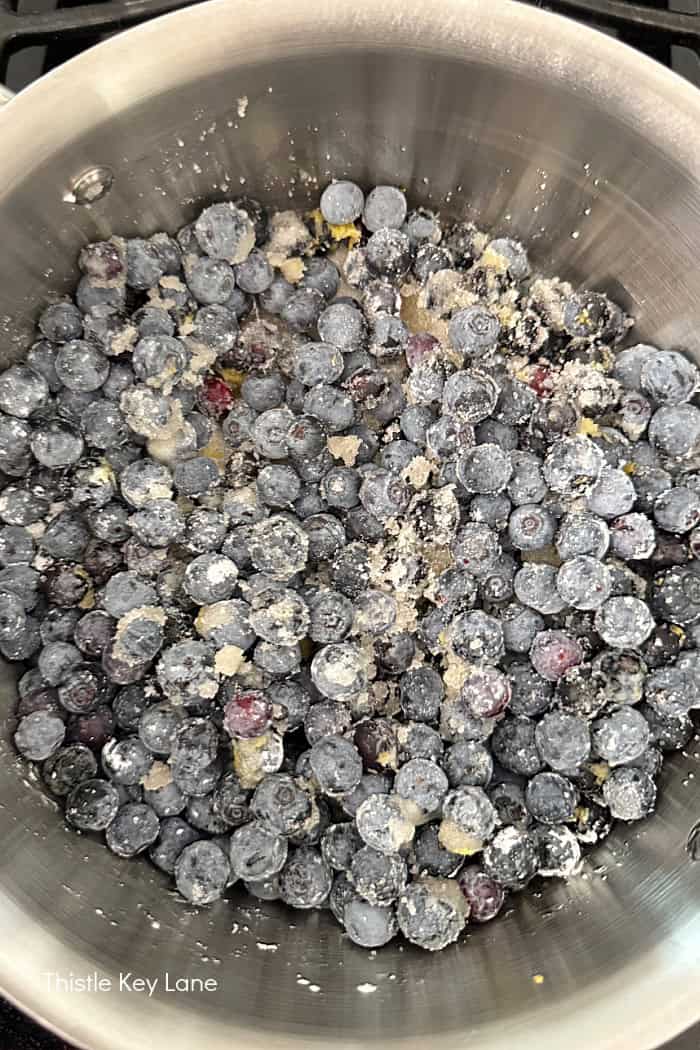 Mixing all ingredients together to coat blueberries.