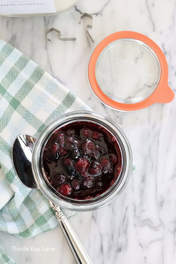 Top view of jar and spoon. Blueberry Compote Recipe.