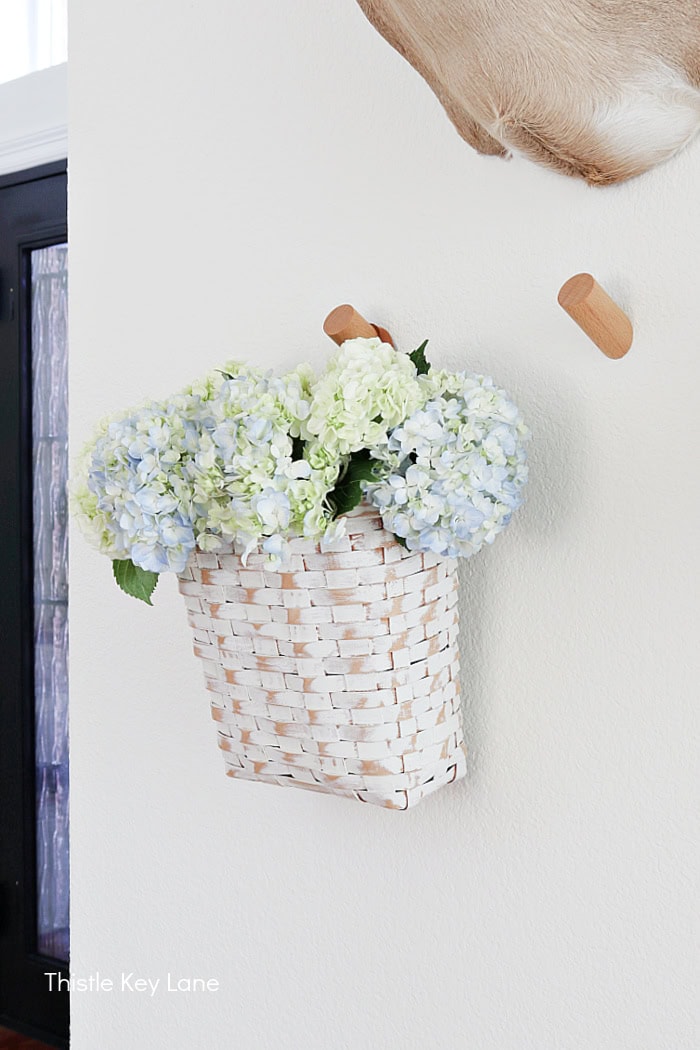 Wall basket with blue and green hydrangeas. 