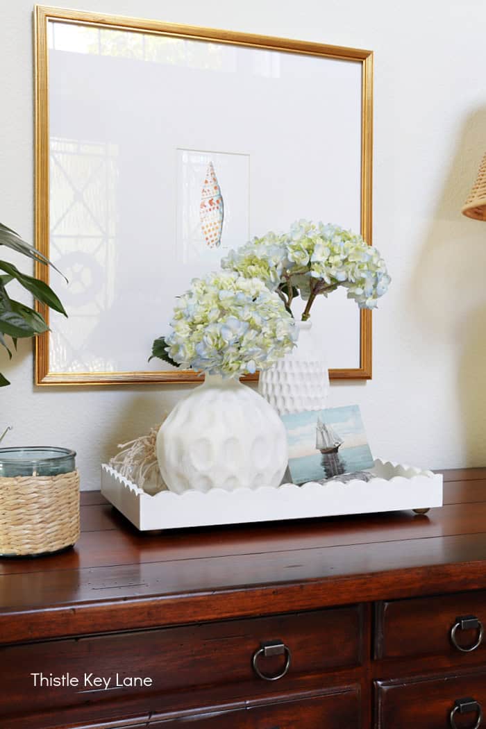 White tray with vases and flowers. Coastal Cottage Entry Table.