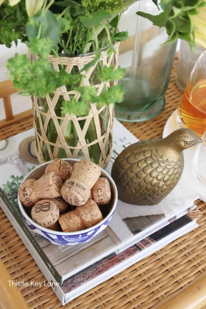 Bowl of champagne corks and a brass quail. Summer To Fall Bar Cart With Sunflowers.