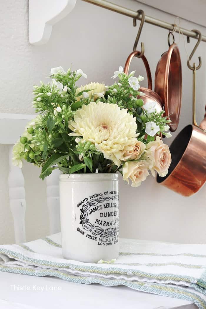 Fresh flowers in ironstone pot.