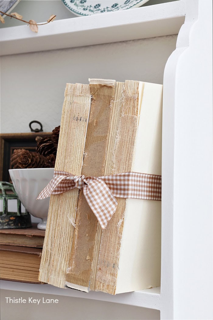 Vintage books with gingham ribbon tie. Early Fall Plate Rack Styling.