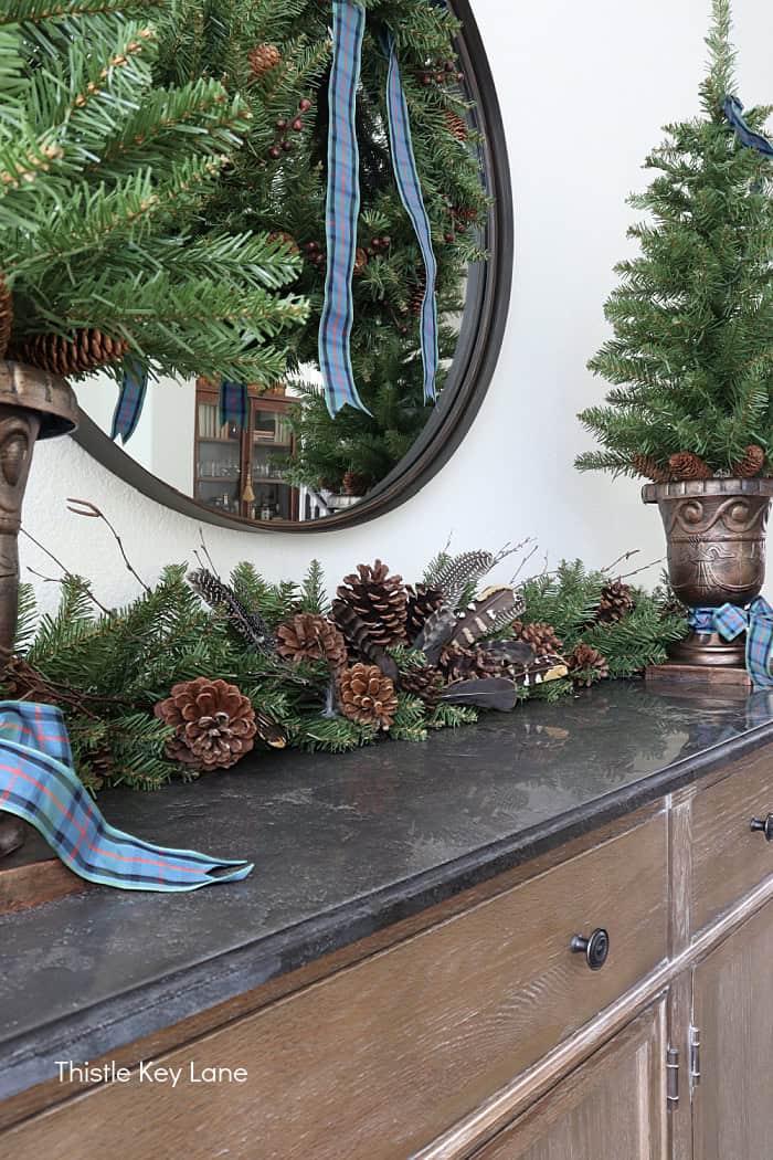 Pinecones and greenery on table top. Easy Plan Ahead Christmas Decorating.