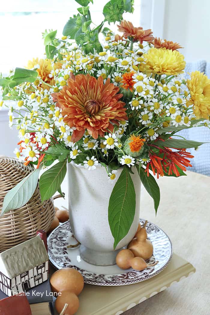 Orange, yellow and white flowers for fall. Autumn Vintage Cottage Vignette.