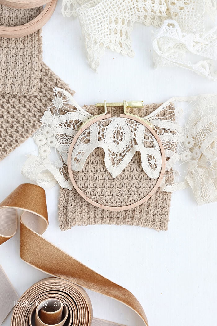 Scrap of vintage lace over a square pice of knited sweater.