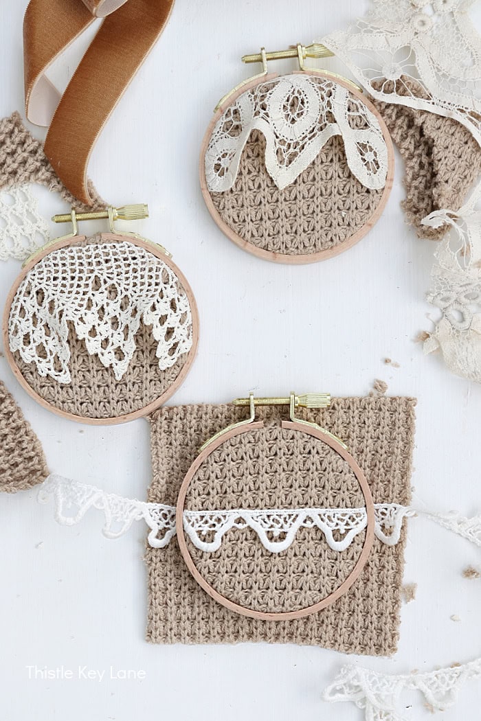 Embroidery hoops with lace and crochet trims in neutral tones. Embroidery Hoop Ornaments From Sweaters.