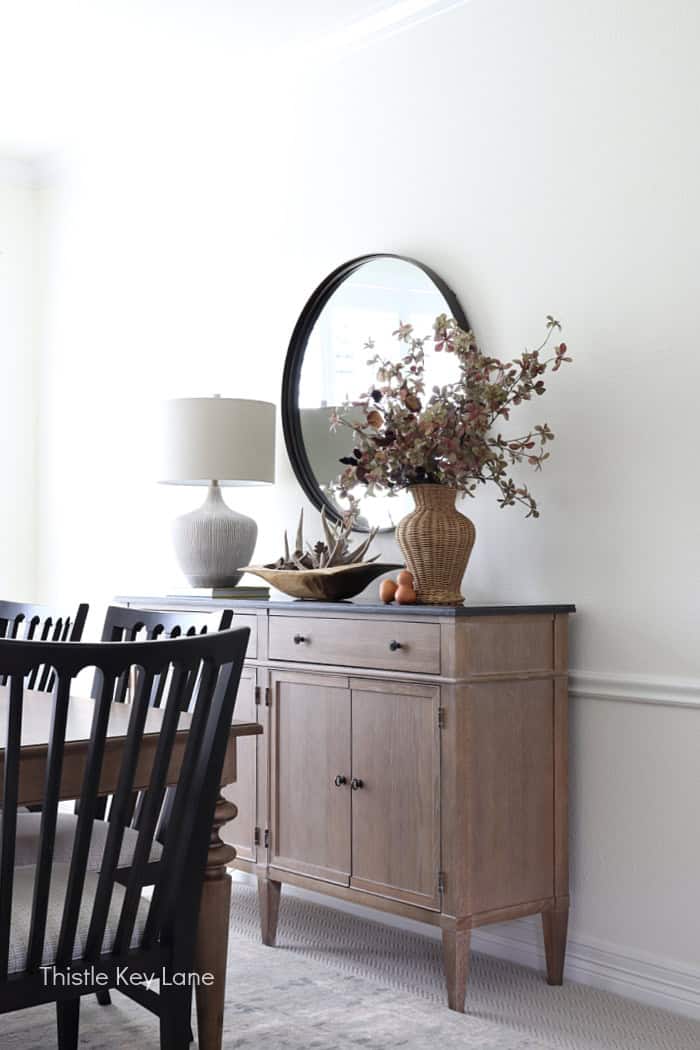 Buffet or sideboard with mirror and vase with seasonal stems. Dining Room Update And Fall Styling.