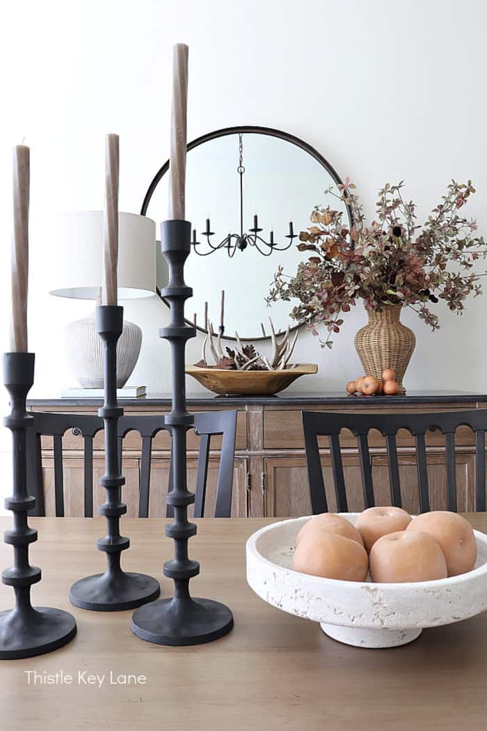 Metal candle stick holders and a stone bowl with faux apples. Dining Room Update And Fall Styling.