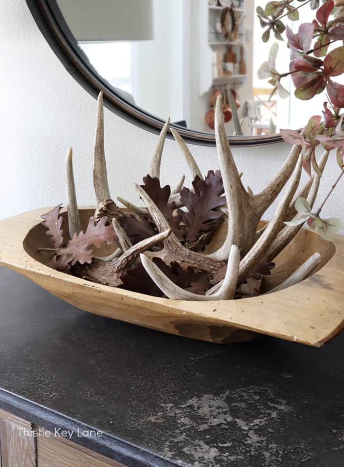 Vintage wood dough bowl with deer sheds and leaves. 
