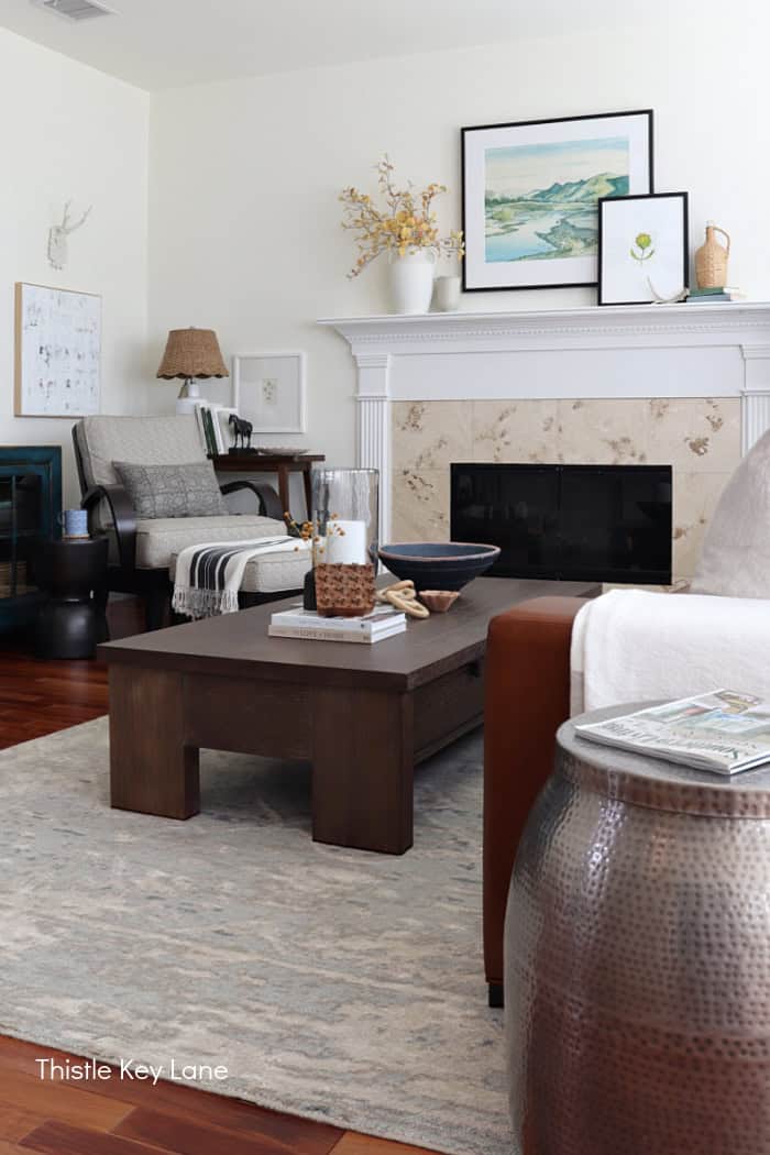 Cozy living room with fireplace, fall decor, and dark wood furniture. Cozy Autumn Family Room Decor.