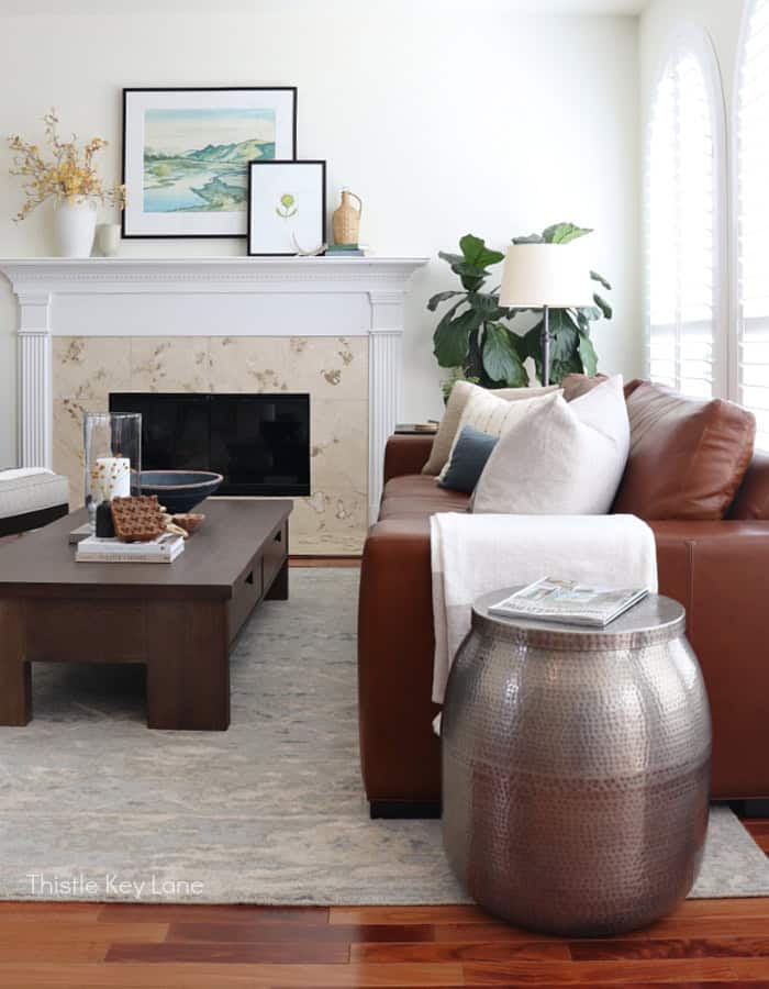 Cozy living room with fireplace, leather sofa, and modern decor, showcasing stylish interior design. Cozy Autumn Family Room Decor. Cozy Autumn Family Room Decor.