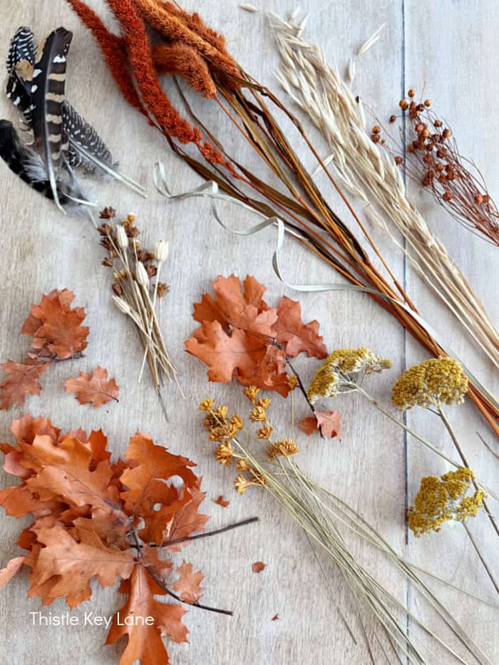 Dried florals in groups on a table.