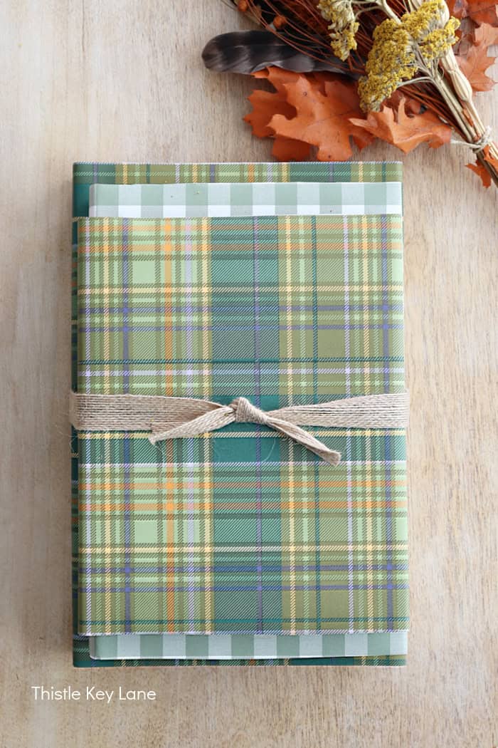 Jute ribbon tied around books. Fall Dried Florals Book Vignette - Thistle Key Lane.