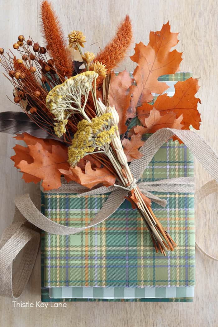 How to tie a dried bouquet to the top of a book vignette.