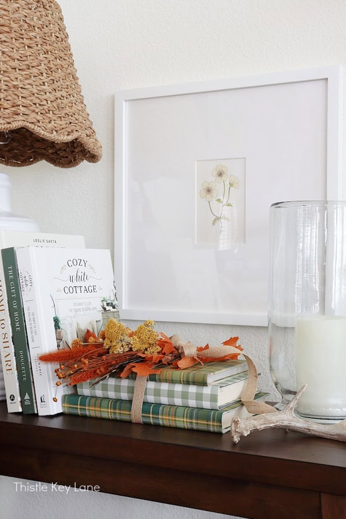 Lamp, artwork, books and candle.