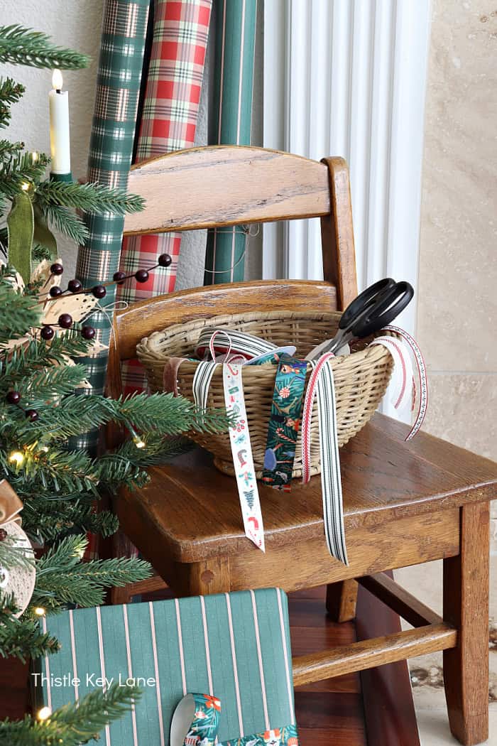 Wrapping paper and ribbons by the tree. Country Cottage Christmas Home Tour.